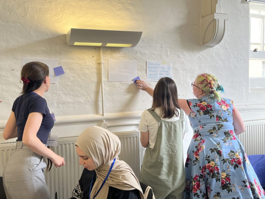 A group of women standing around a wall