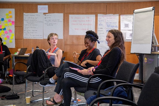 A group of women sitting in chairs