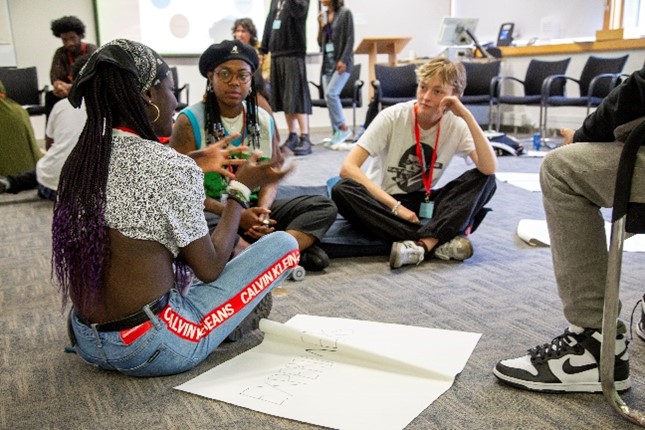 A group of people sitting on the floor