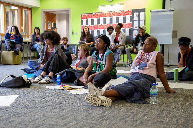 A group of people sitting on the floor